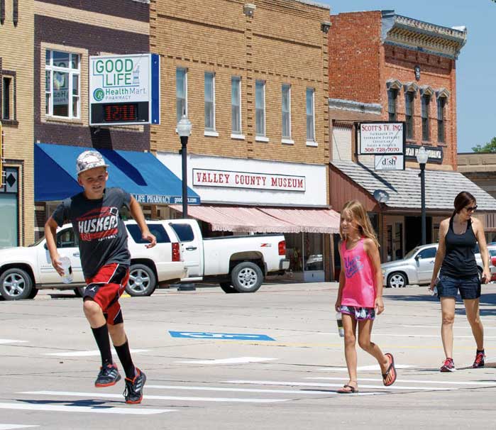 youth crossing rural street downtown