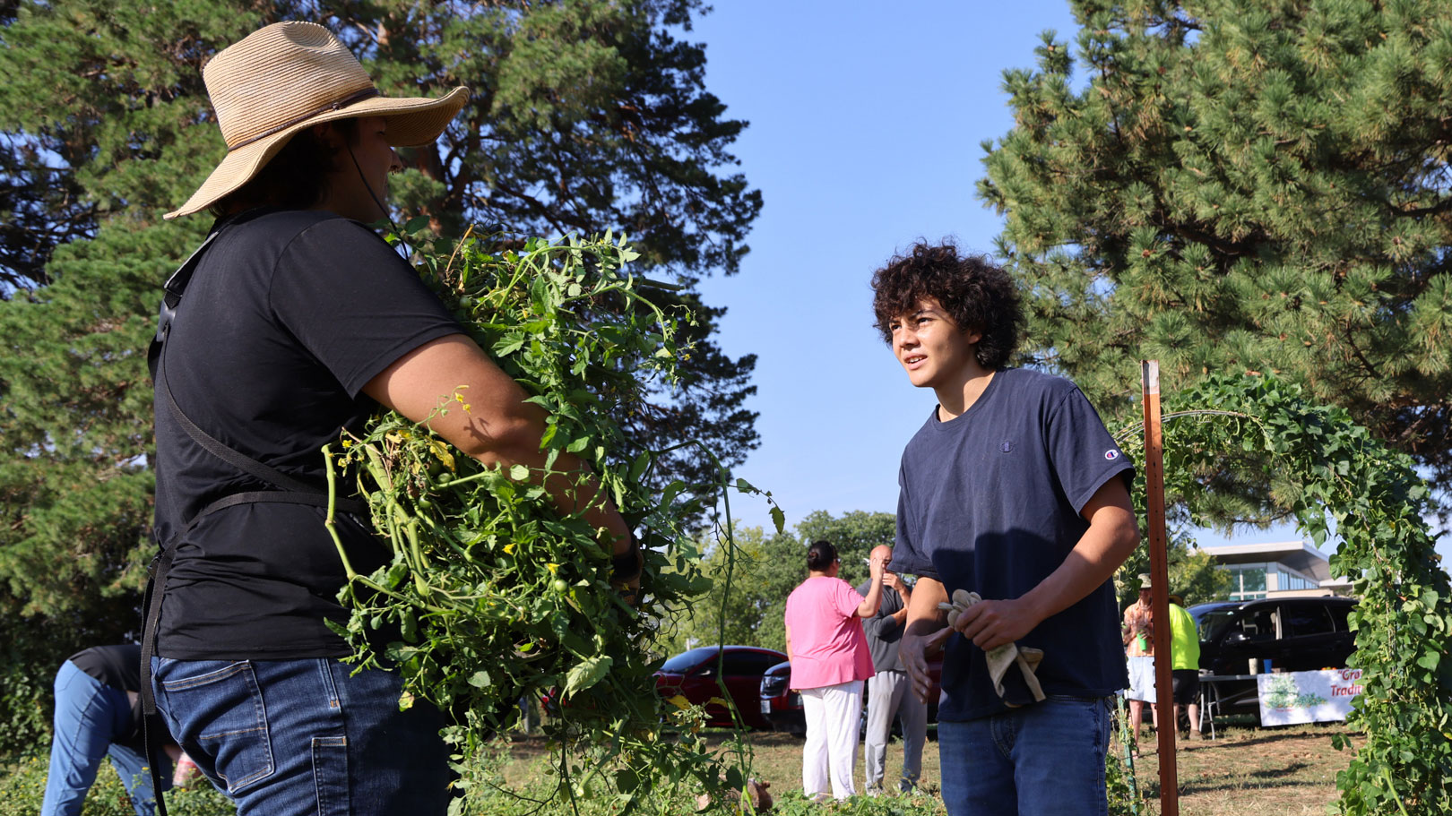 Timothy Thielen (left) talks with a member of the Turtle Island Indigenous Youth Growers