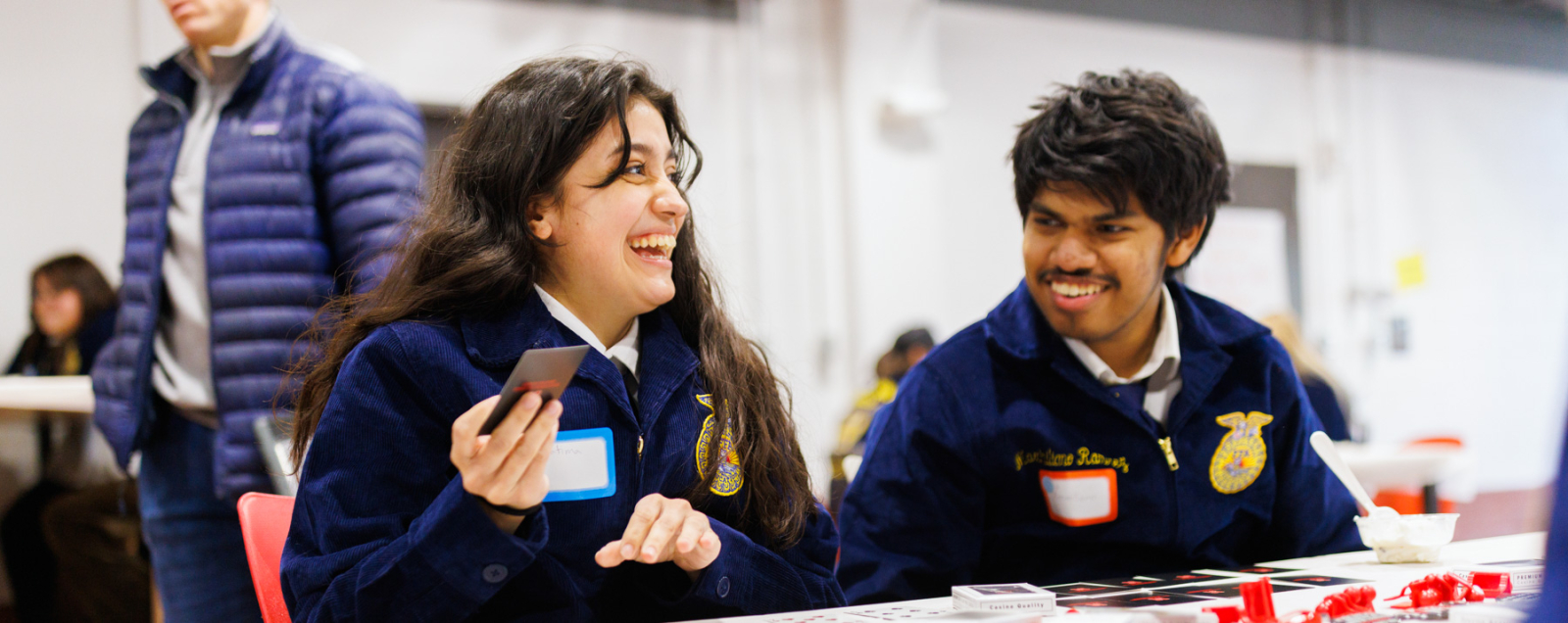 Students laughing playing cards