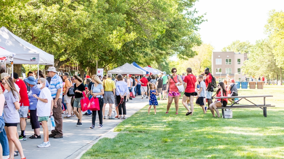 Shoppers visit tents of vendors at East Campus Discovery Days.