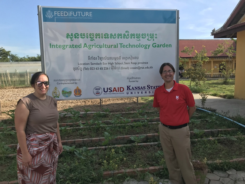 PhD student Raquel Taylor (left) and Nebraska ALEC faculty member Nathan Conner (right) pose alongside the Farmer-to-Farmer Integrated Agricultural Technology Garden at Samdach Euv High School in the Siem Reap province of Cambodia